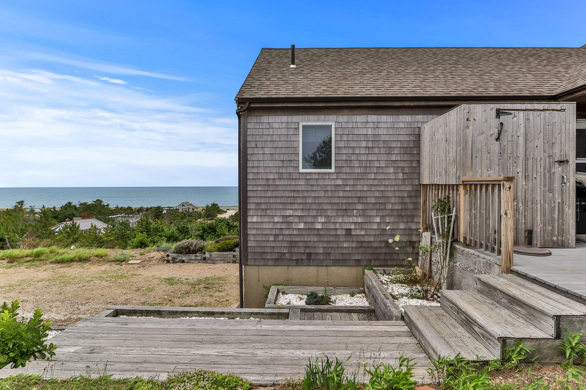 25 Great Hills Road Truro, MA 02666 - Photo 47 of 68 a back view of a house with a yard