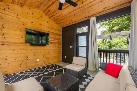 a balcony with furniture and a flat screen tv