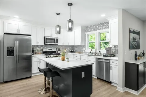 a kitchen with refrigerator cabinets and center island