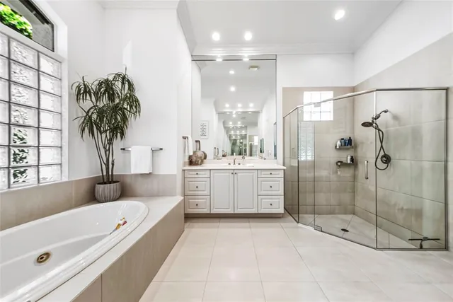 a bathroom with a tub a sink shower and mirror