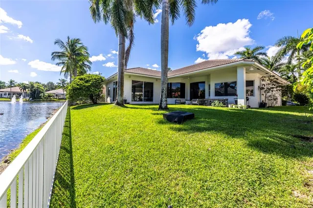 a view of a house with swimming pool and porch with furniture