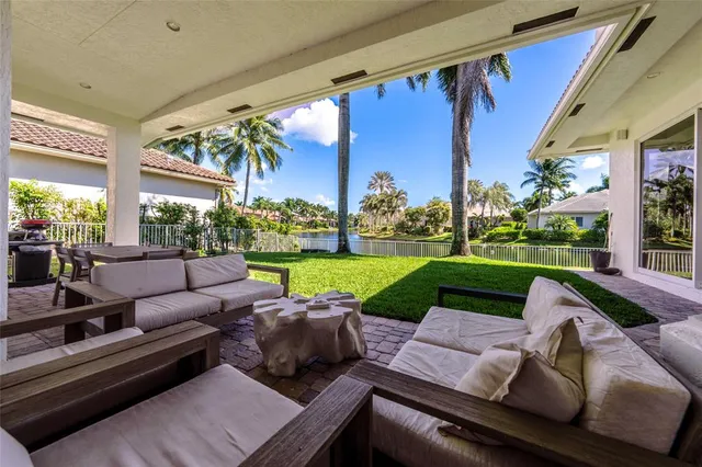 a view of a patio with couches chairs and a big yard