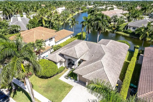 an aerial view of a house with swimming pool and outdoor seating