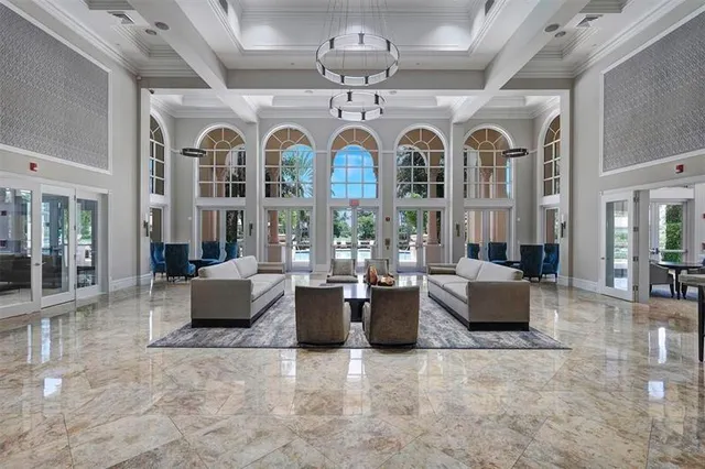 a view of a living room filled with furniture and chandelier