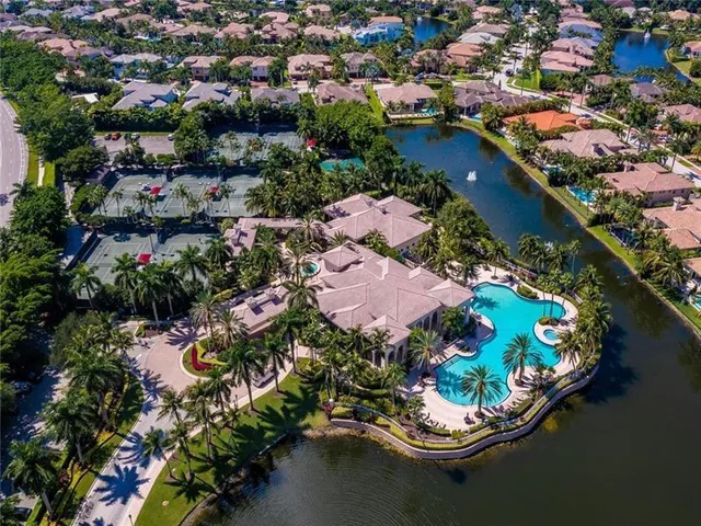 an aerial view of a houses with a lake and lake view