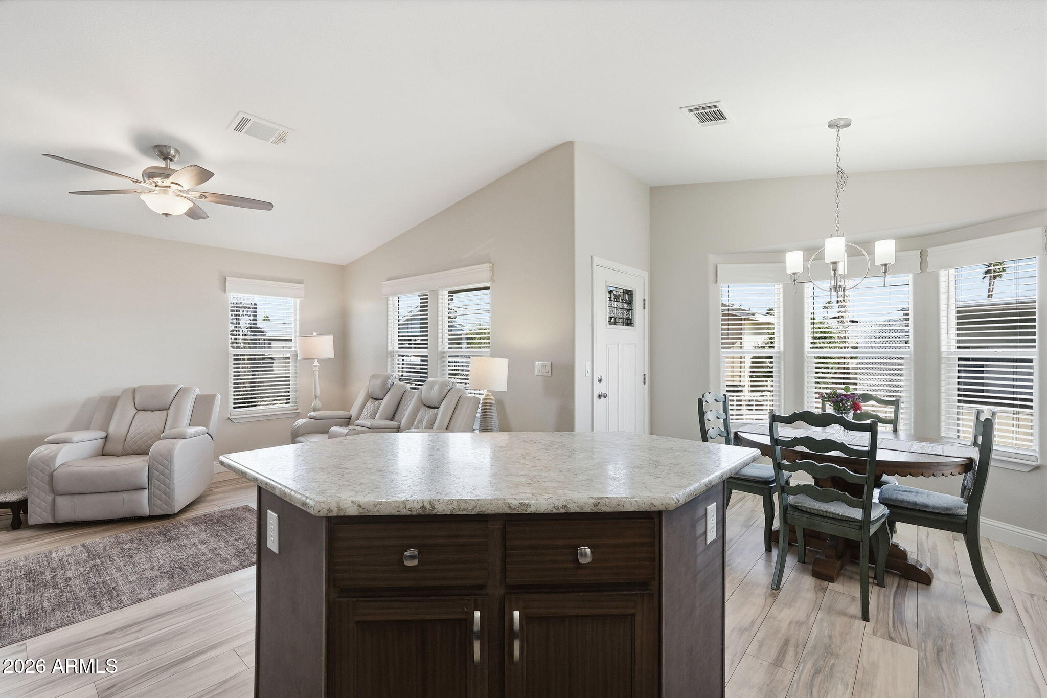 8865 East Baseline Road, Unit 1417 Mesa, AZ 85209 - Photo 14 of 47 a view of a kitchen area with furniture and wooden floor
