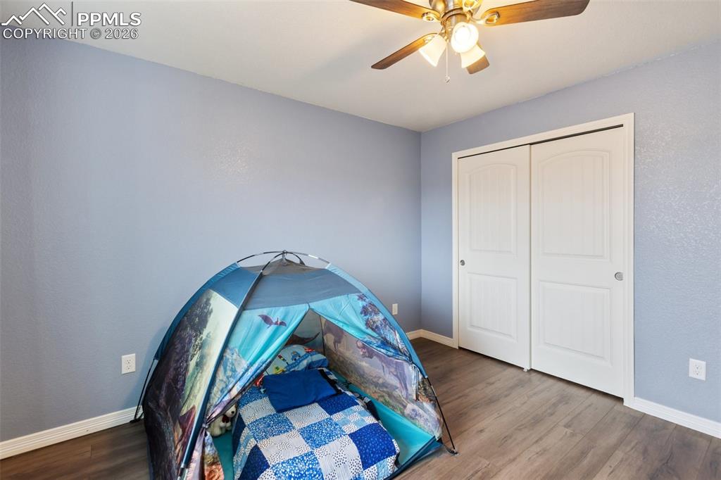 8458 Chasewood Loop Colorado Springs, CO 80908 - Photo 22 of 34 an entryway with wooden floor and a chandelier fan