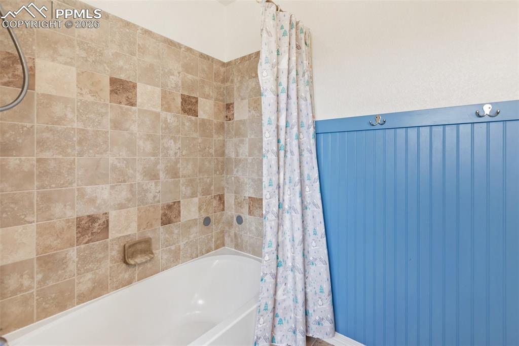 8458 Chasewood Loop Colorado Springs, CO 80908 - Photo 26 of 34 a bathroom with a bathtub and shower