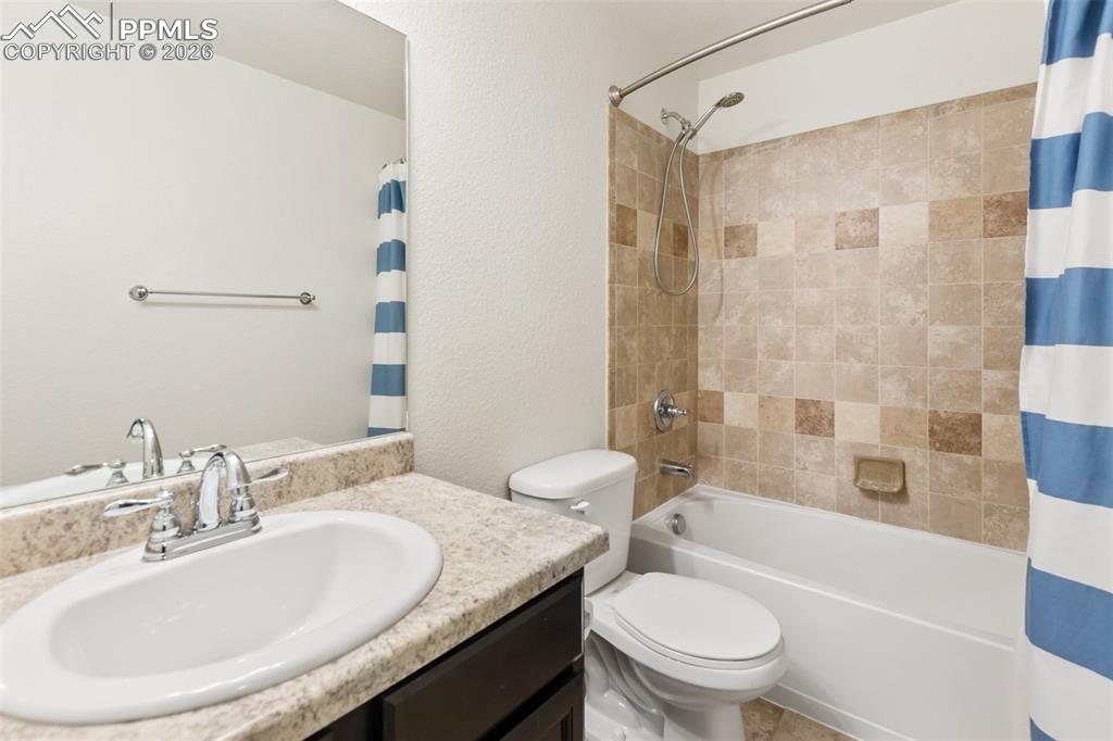 8458 Chasewood Loop Colorado Springs, CO 80908 - Photo 30 of 34 a bathroom with a granite countertop sink toilet and shower