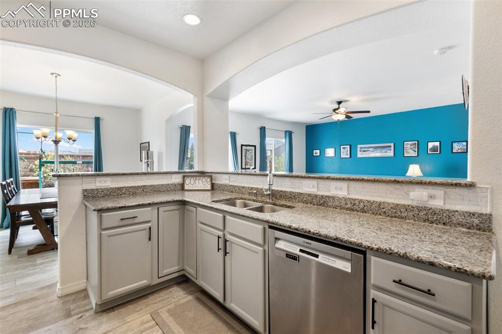 8458 Chasewood Loop Colorado Springs, CO 80908 - Photo 4 of 34 a kitchen with a sink and a stove