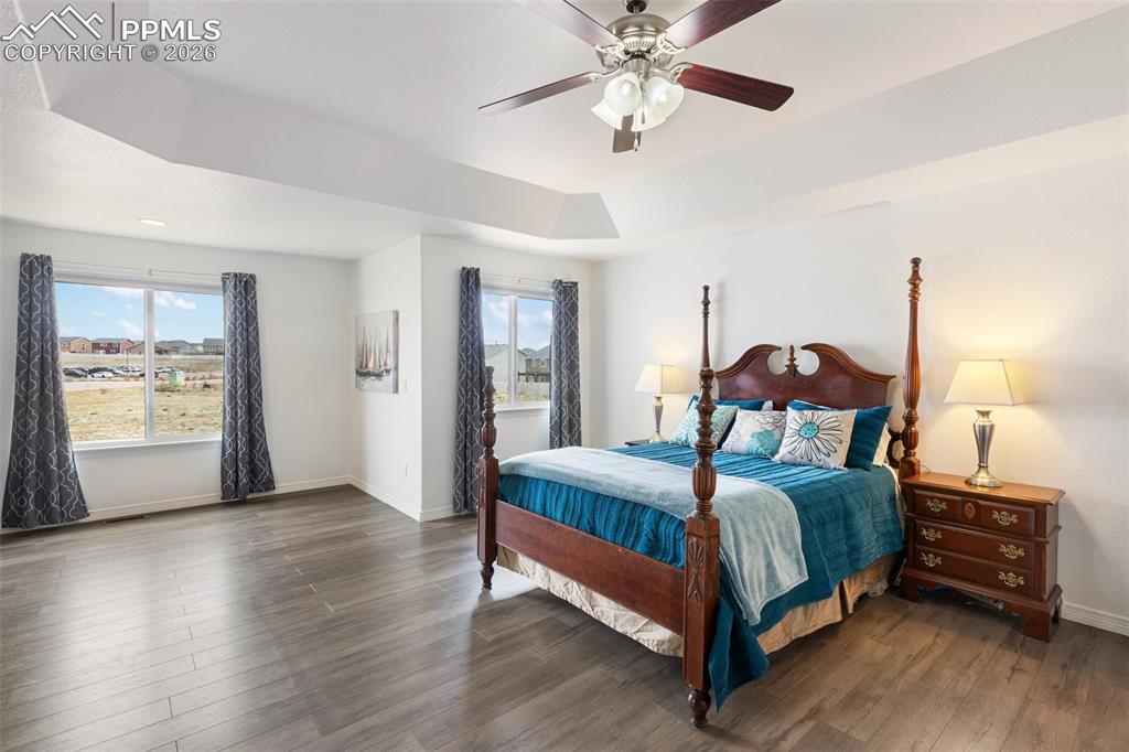 8458 Chasewood Loop Colorado Springs, CO 80908 - Photo 5 of 34 a bedroom with a bed and a chandelier