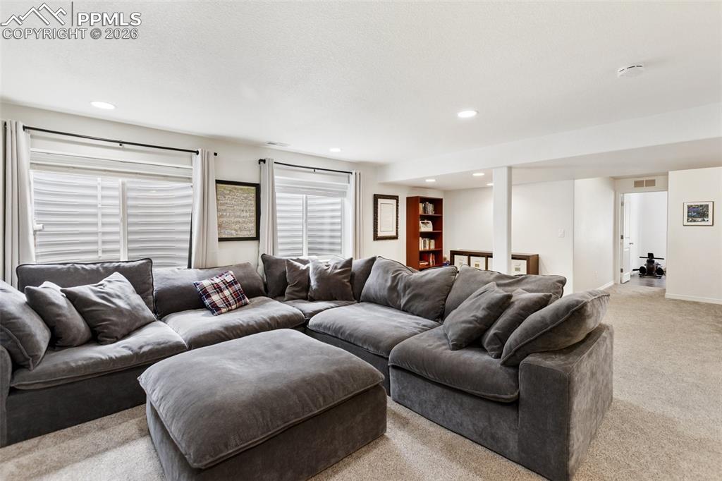 8458 Chasewood Loop Colorado Springs, CO 80908 - Photo 7 of 34 a living room with furniture and a large window