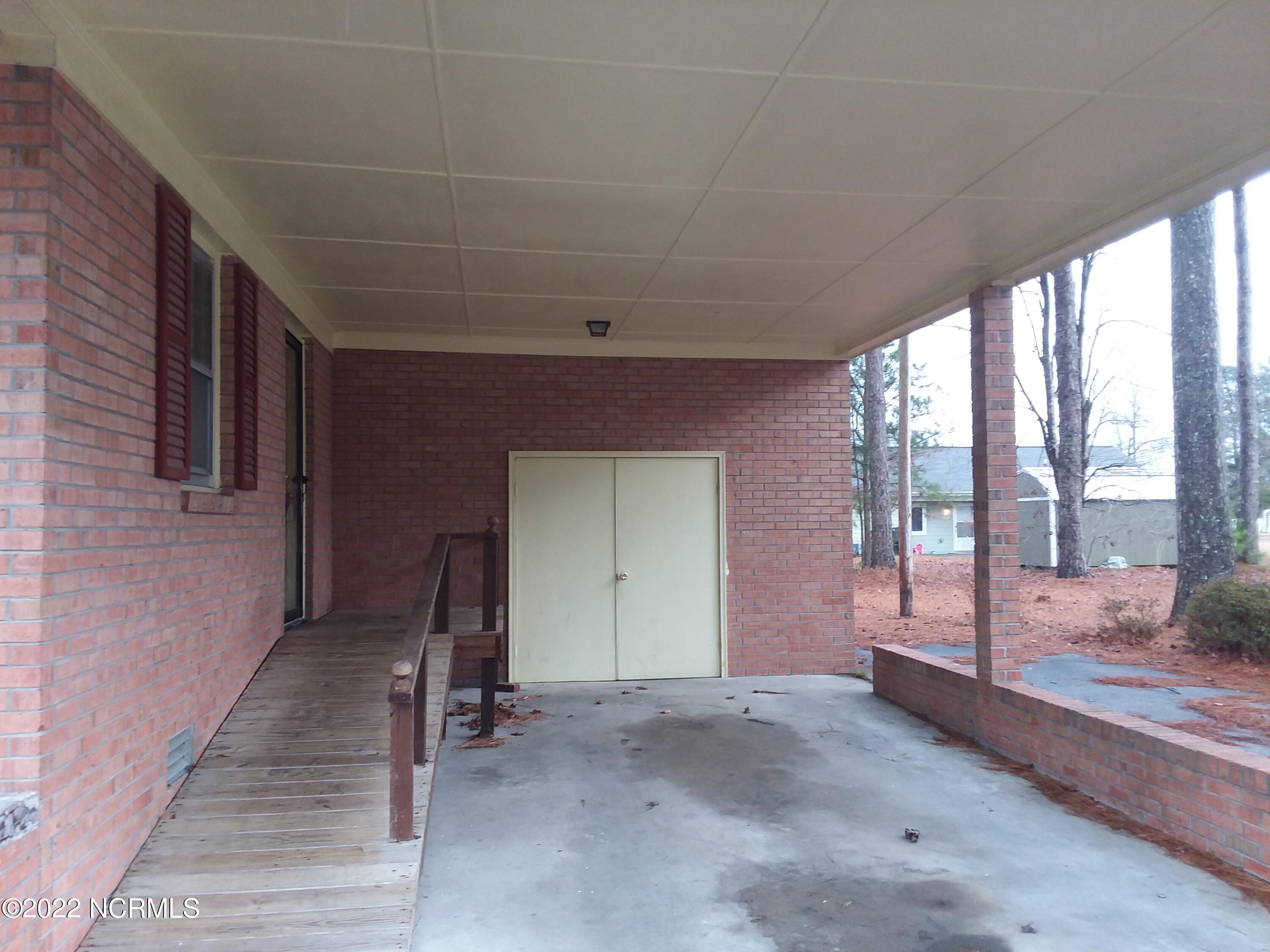 1205 Lockwood Road Kinston, NC 28501 - Photo 13 of 14 Carport with Storage Room
