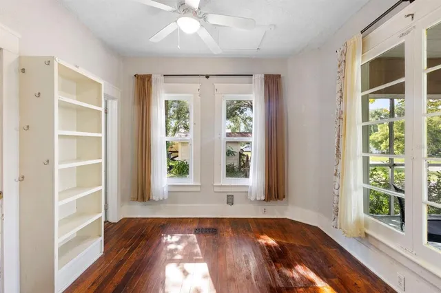 a view of an entryway with wooden floor and door