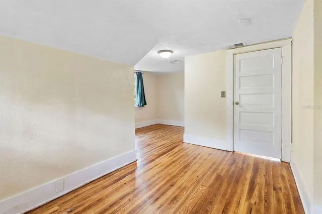 a view of hallway with wooden floor
