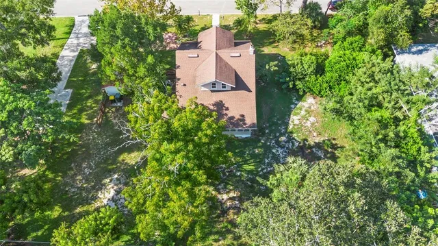 an aerial view of a house with a yard and garden