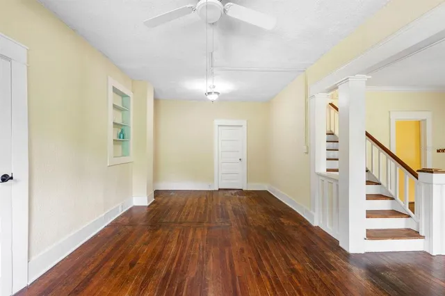 wooden floor in an empty room with a window