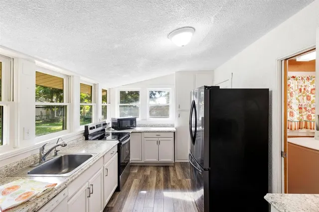 a kitchen with a sink stove and refrigerator