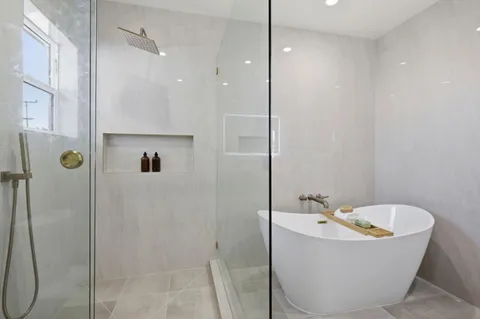 a bathroom with a bathtub and shower