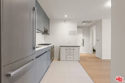 a kitchen with stainless steel appliances a refrigerator and a stove