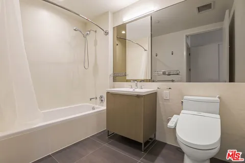 a bathroom with a sink mirror vanity and toilet