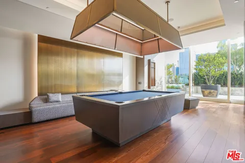 a living room with hard wood floors and a large counter