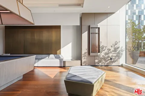 a view of a balcony with wooden floor and iron fence