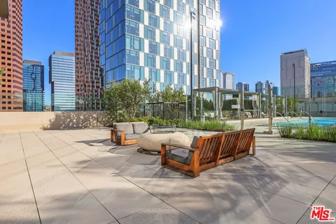 a swimming pool with outdoor seating and yard
