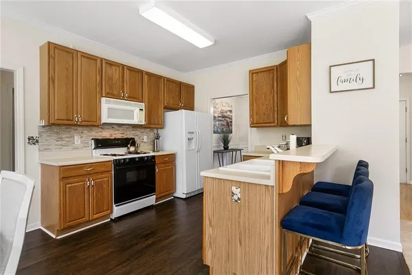 a kitchen with a refrigerator stove top oven and sink
