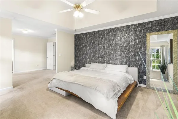 a bedroom with a bed and a chandelier