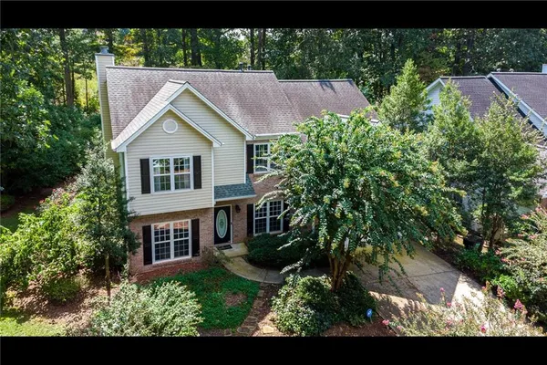 a aerial view of a house with a yard and potted plants