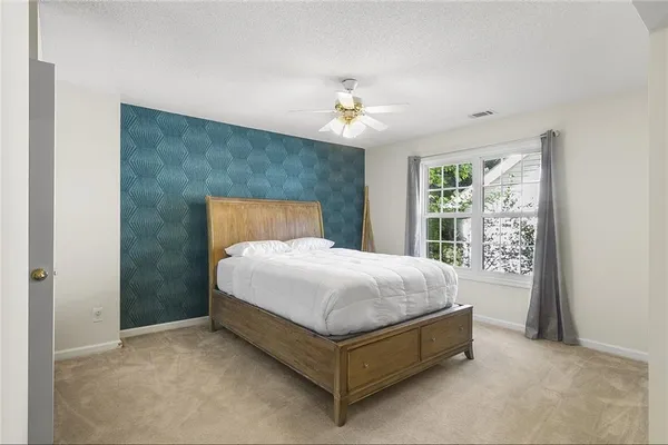 a spacious bedroom with a bed and a window