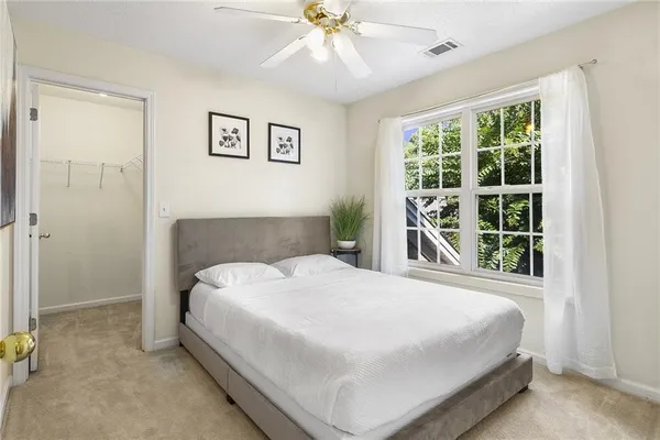 a bedroom with a bed and a large window