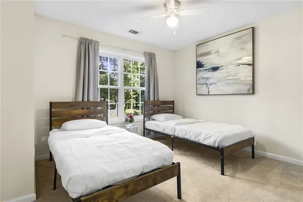 a bedroom with two beds and a chandelier