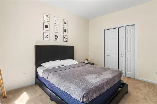 a bedroom with a bed and wall painting