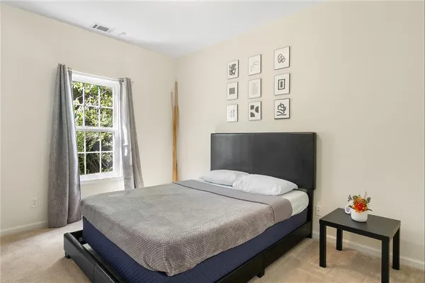 a bedroom with a bed and a window