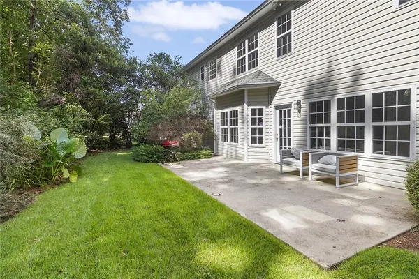 a view of a house with backyard and sitting area