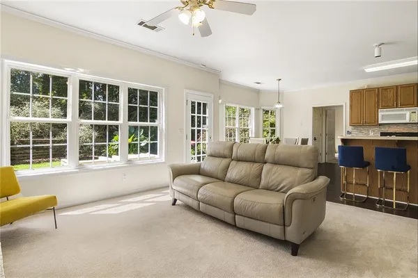 a living room with furniture and a large window