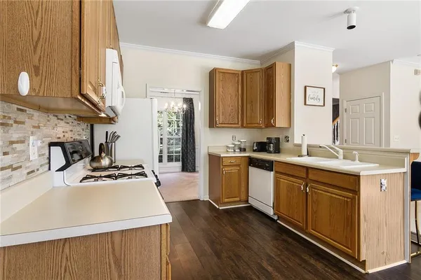 a kitchen with a sink stove and cabinets