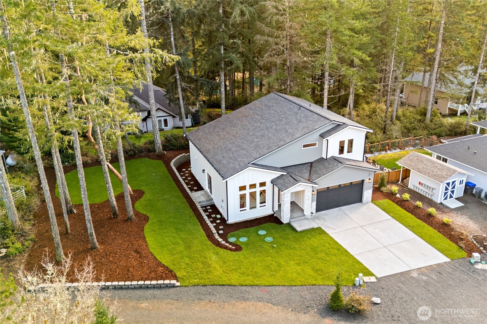 31 East Rhododendron Court Union, WA 98592 - Photo 36 of 38 an aerial view of a house with swimming pool garden and patio