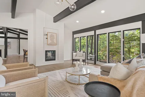 a living room with furniture and large windows