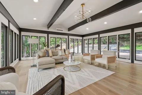 a bed sitting in a bedroom next to a large window