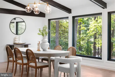 a dining room with furniture window and wooden floor