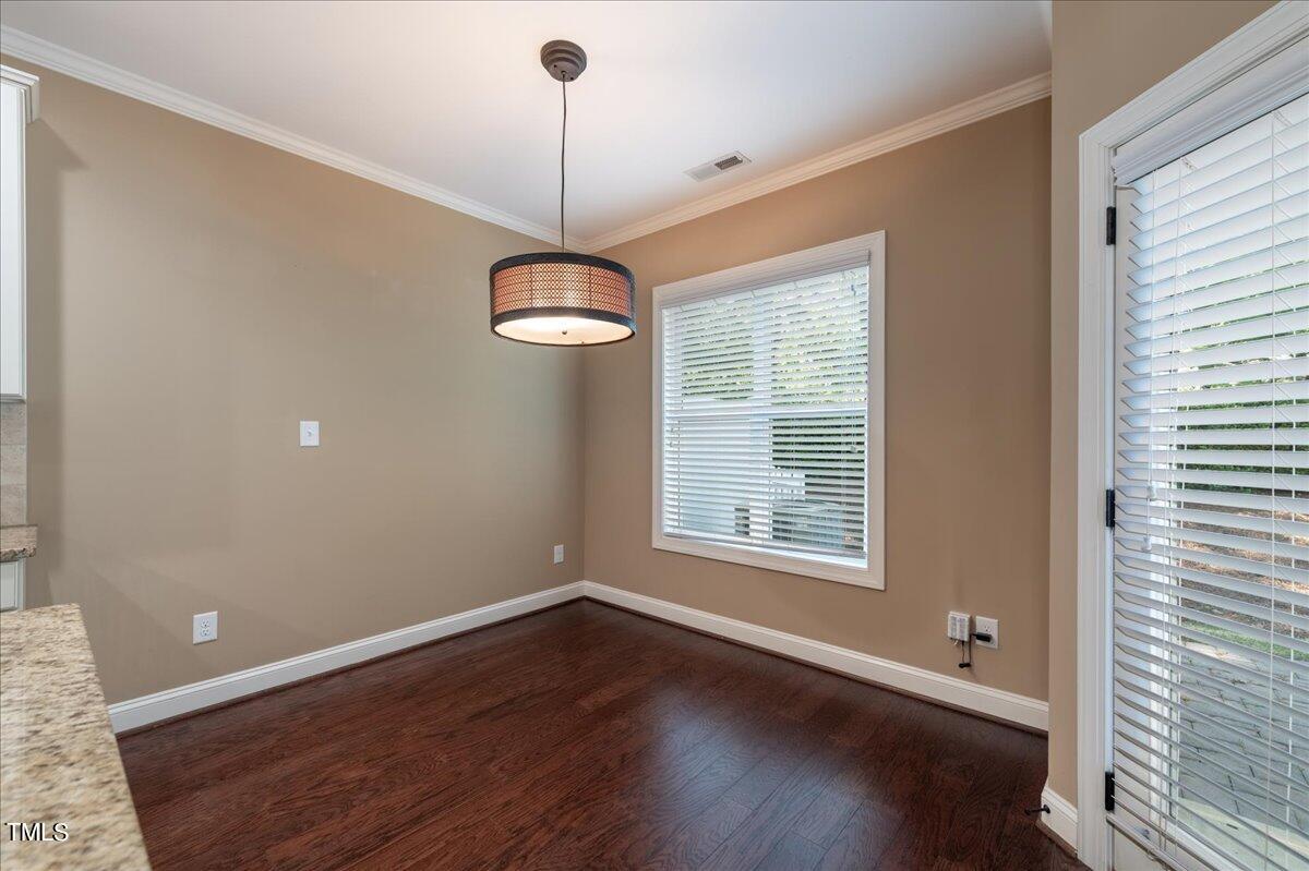 2115 Scarlet Maple Drive Raleigh, NC 27606 - Photo 12 of 32 a view of an empty room with wooden floor and a window