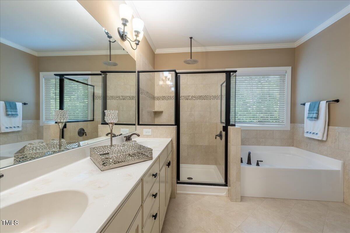 2115 Scarlet Maple Drive Raleigh, NC 27606 - Photo 19 of 32 a bathroom with a tub sink and mirror