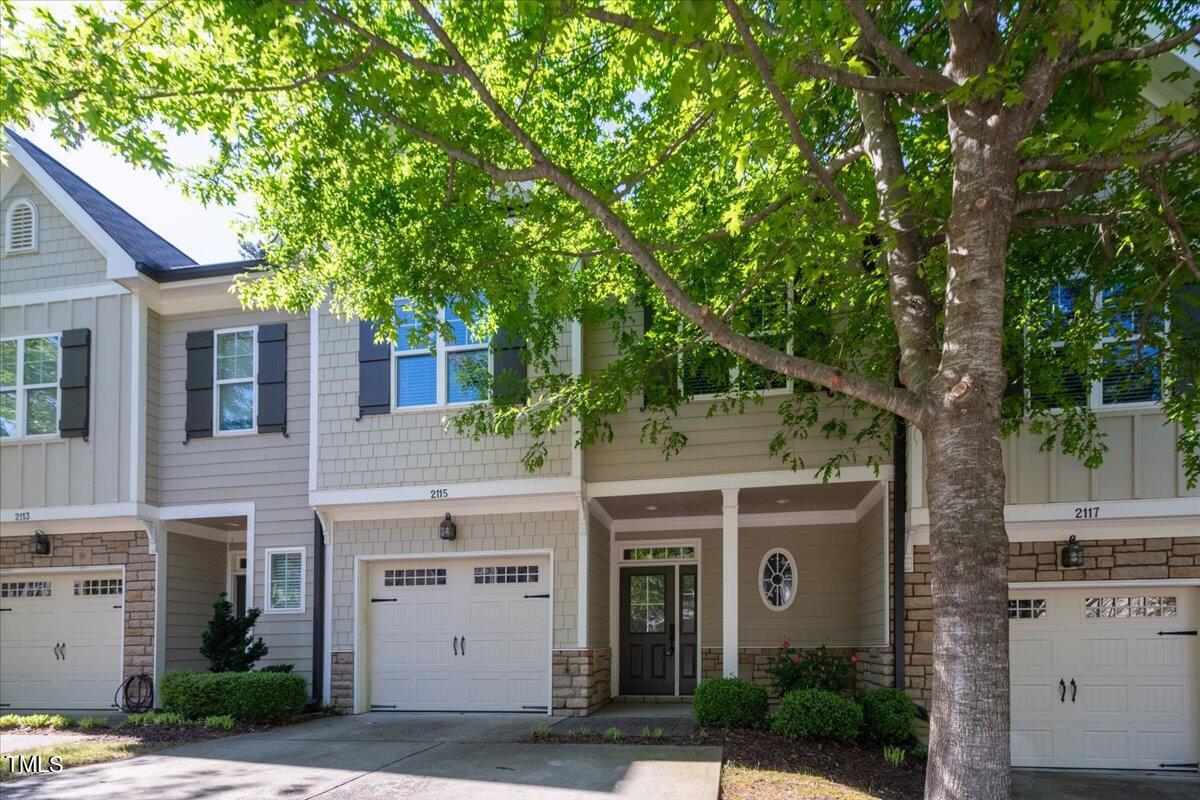 2115 Scarlet Maple Drive Raleigh, NC 27606 - Photo 2 of 32 a front view of a house with a garden