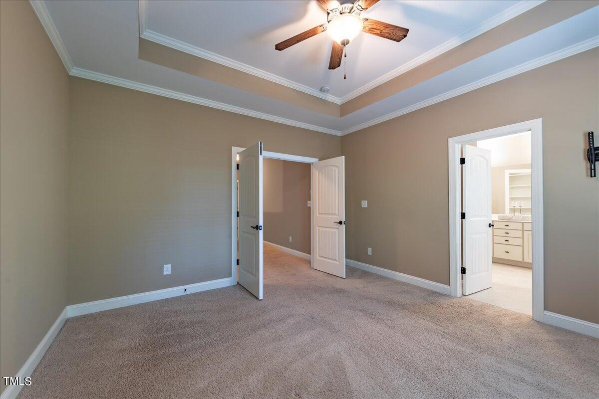 2115 Scarlet Maple Drive Raleigh, NC 27606 - Photo 21 of 32 an empty room with chandelier fan and windows