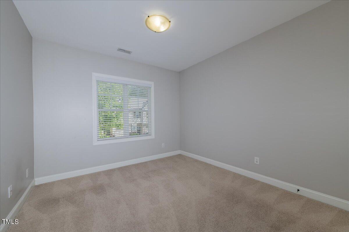 2115 Scarlet Maple Drive Raleigh, NC 27606 - Photo 25 of 32 an empty room with a window