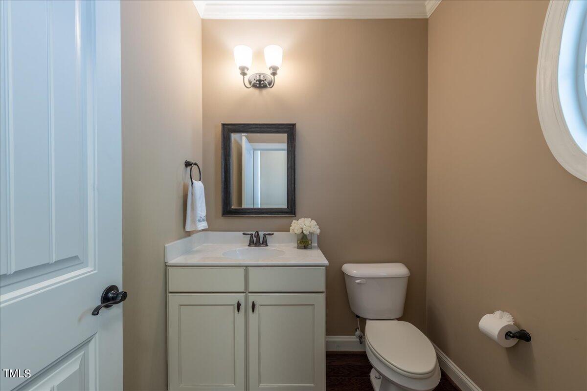 2115 Scarlet Maple Drive Raleigh, NC 27606 - Photo 5 of 32 a bathroom with a toilet sink and mirror