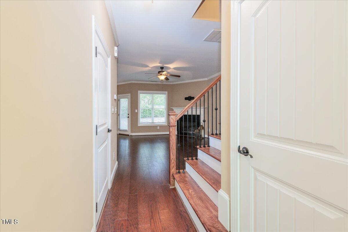 2115 Scarlet Maple Drive Raleigh, NC 27606 - Photo 8 of 32 a view of a hallway with wooden floor and staircase
